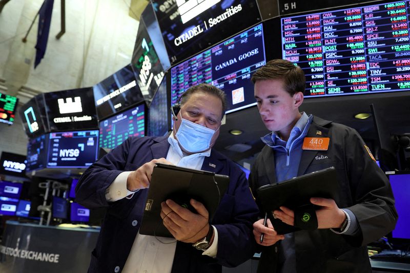 FILE PHOTO: Traders work on the floor of the NYSE