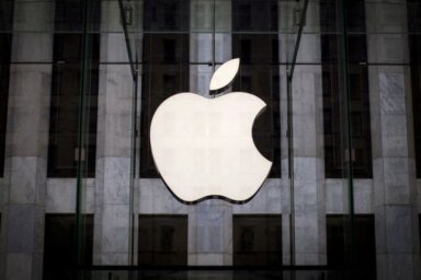 FILE PHOTO: An Apple logo hangs above the entrance to