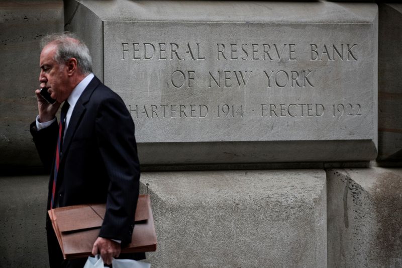 A man walks outside The Federal Reserve Bank of New