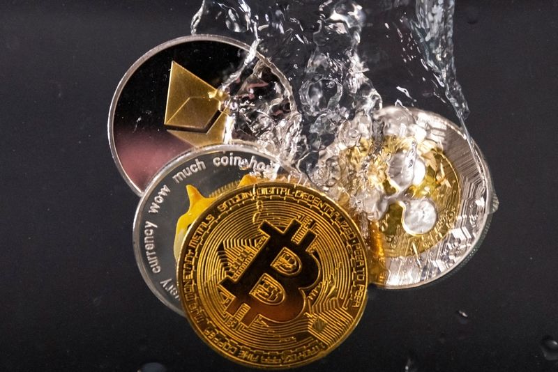 Souvenir tokens representing cryptocurrency networks Bitcoin, Ethereum, Dogecoin and Ripple