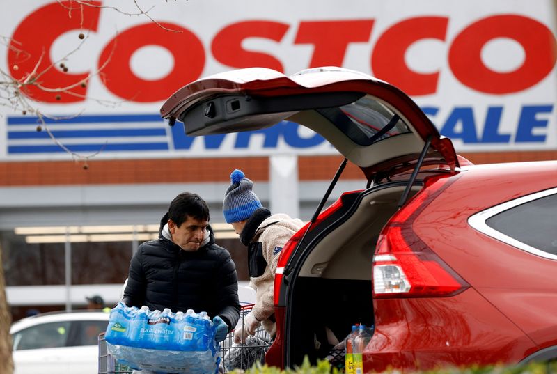 FILE PHOTO: A shopper loads a car with bottled water