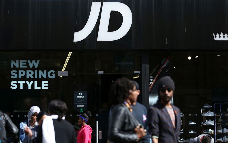 FILE PHOTO: People pass a JD Sports store in London