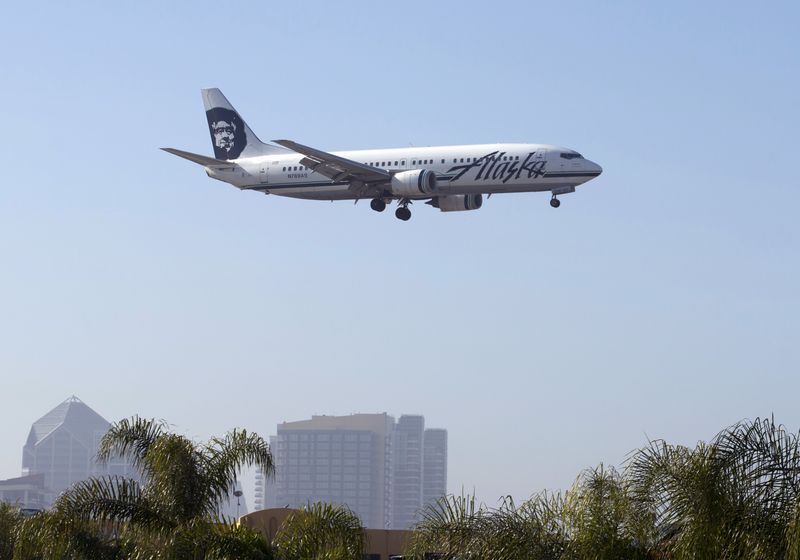 An Alaska Airlines Boeing 737 plane is shown on final