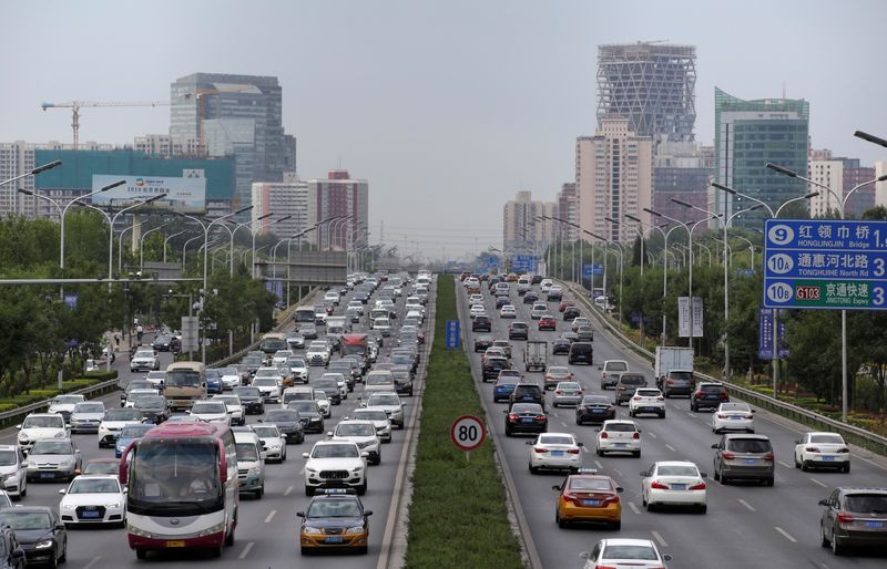 FILE PHOTO: Cars drive on the road during the morning