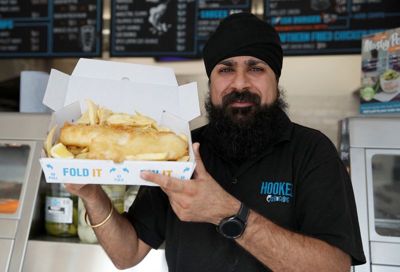 Owner of Hooked Fish and Chips shop, Bally Singh, holds
