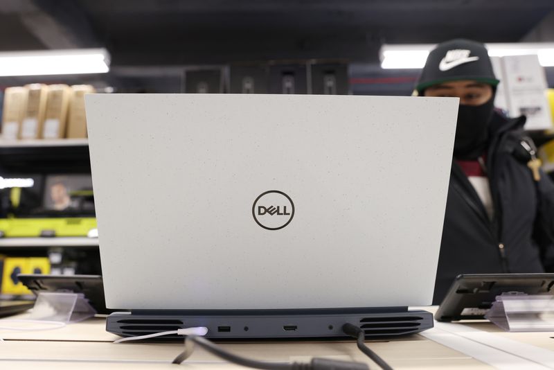 A person looks at a Dell laptop for sale in