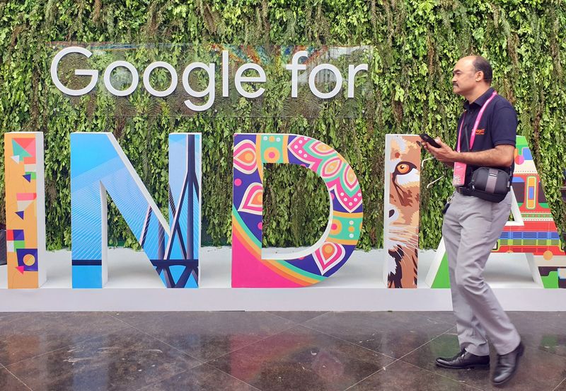 FILE PHOTO: A man walks past the sign ‘Google for