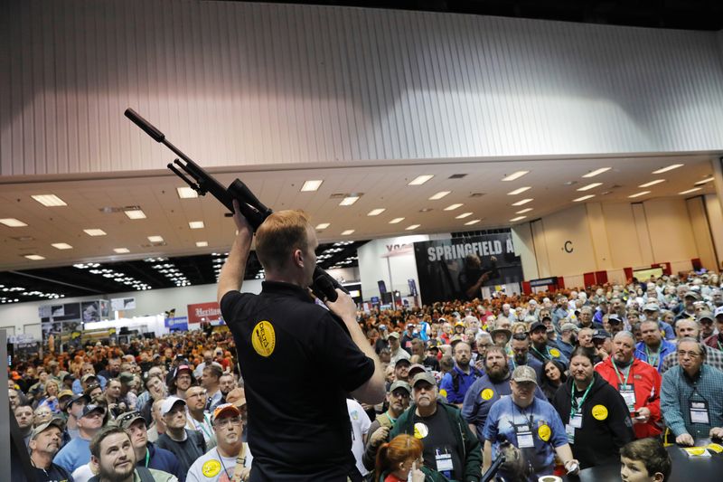 FILE PHOTO: A man auctions off a Daniel Defense rifle