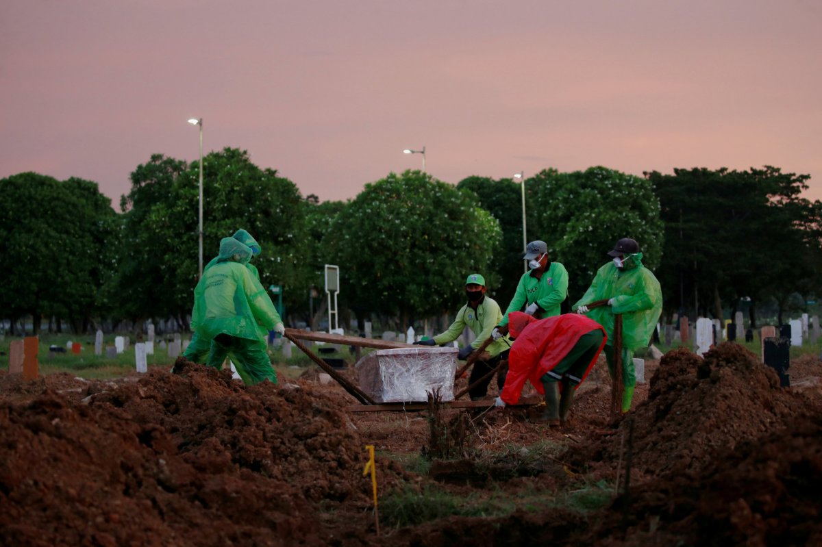 Municipality workers bury a victim of a coronavirus disease (COVID-19)