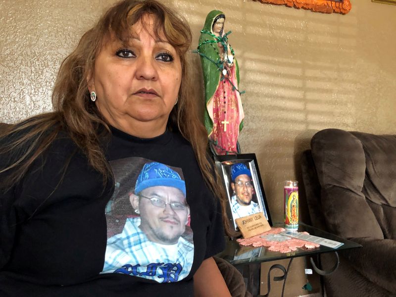 Erma Aldaba sits in her home, wearing a T-shirt emblazoned
