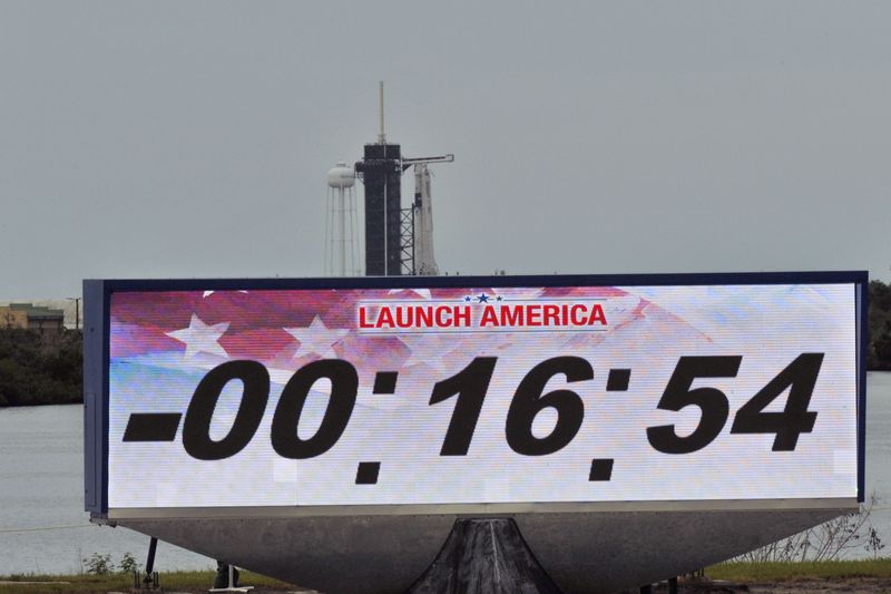 A screen showing the countdown clock is seen with SpaceX