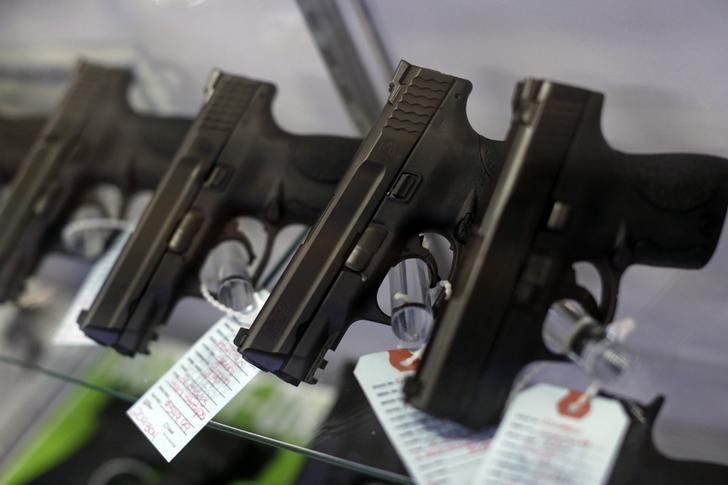 Handguns are seen for sale in a display case at