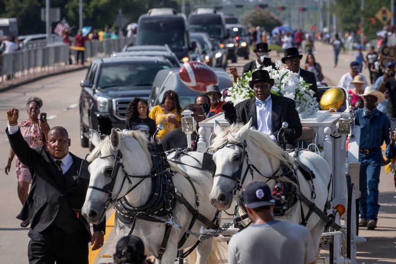Horse drawn carriage with coffin of George Floyd enters cemetery