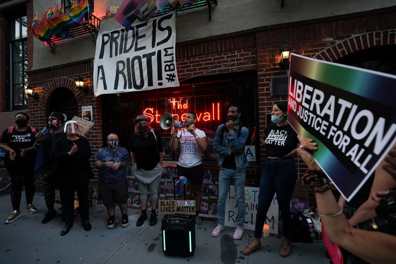 People attend a rally at the Stonewall Inn to support