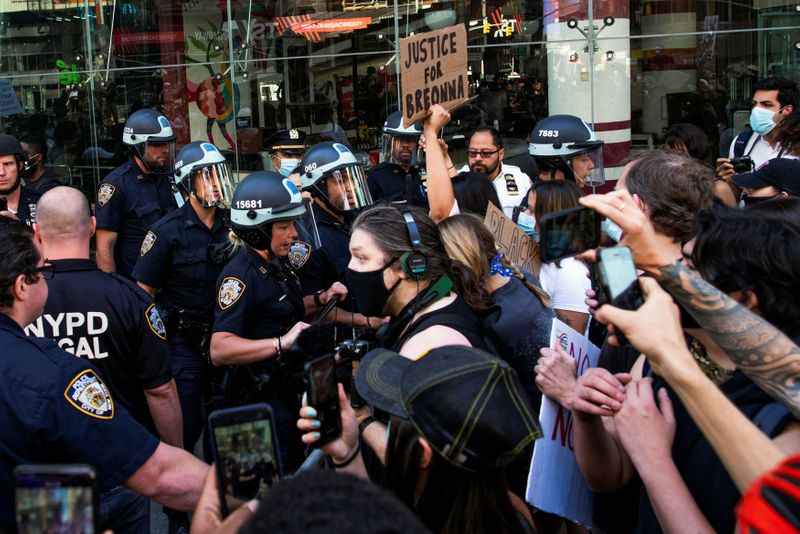 Demonstrators scuffle with NYPD police officers as they try to