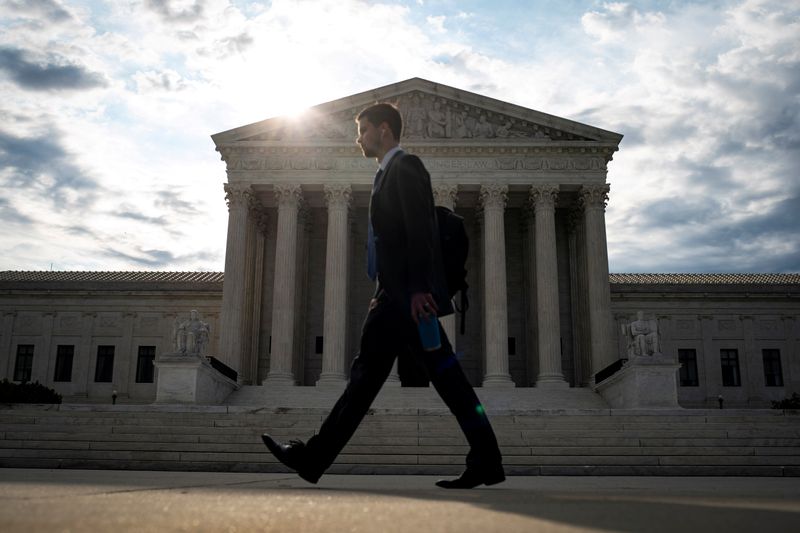 FILE PHOTO: A man walks past the U.S. Supreme Court