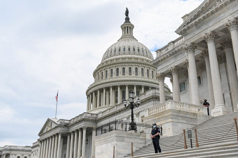 Police officers wearing face masks guard the U.S. Capitol Building