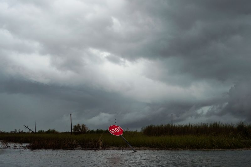 A damaged stop sign and flooding is seen after Hurricane
