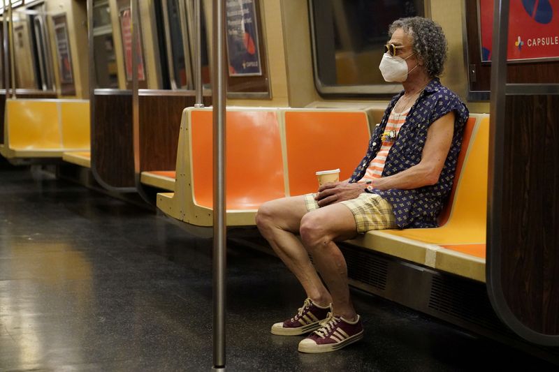 FILE PHOTO: A man rides a subway in the Manhattan