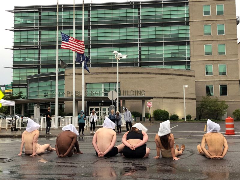 Naked protesters stage a demonstration to protest the death of