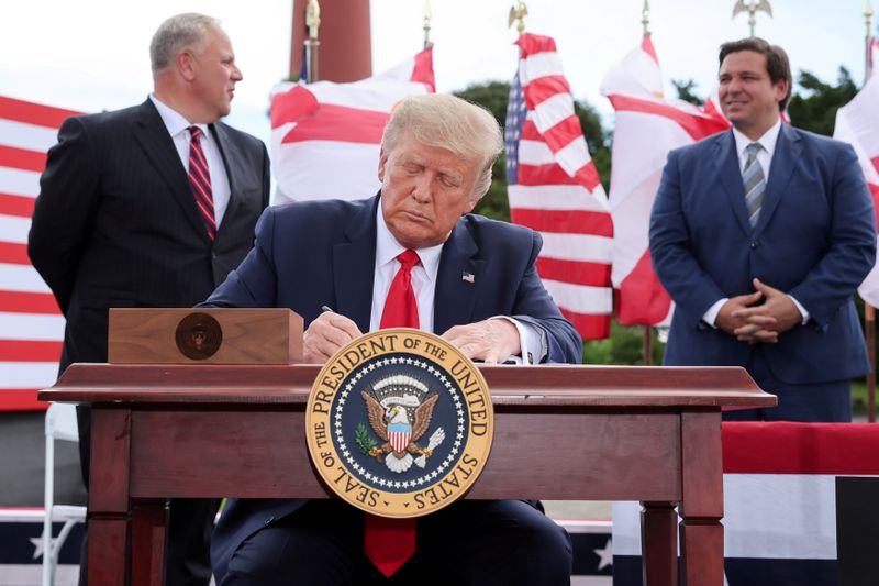 U.S. President Trump delivers signs an extension of the ban