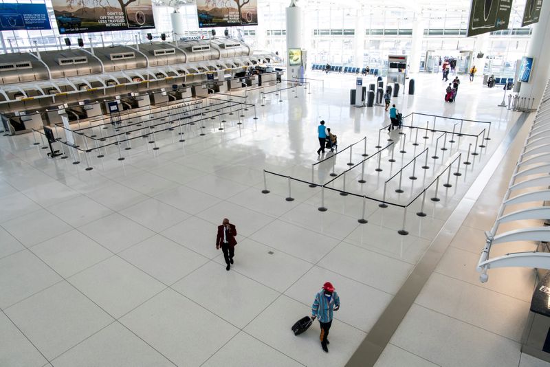 FILE PHOTO: People walk around the terminal at the John