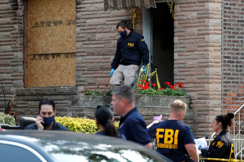 FBI officers outside a house where police say bomb-making materials