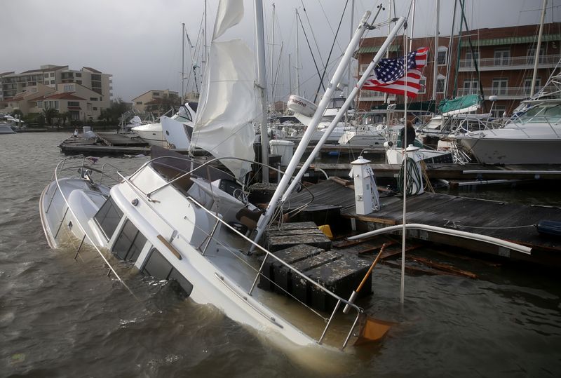 An U.S. flag flies from a boat damaged by Hurricane