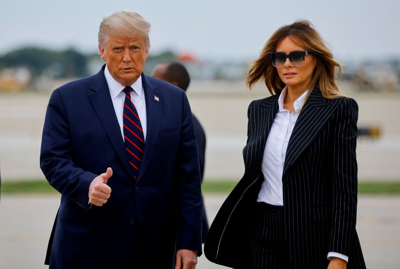 FILE PHOTO: U.S. President Donald Trump walks with first lady
