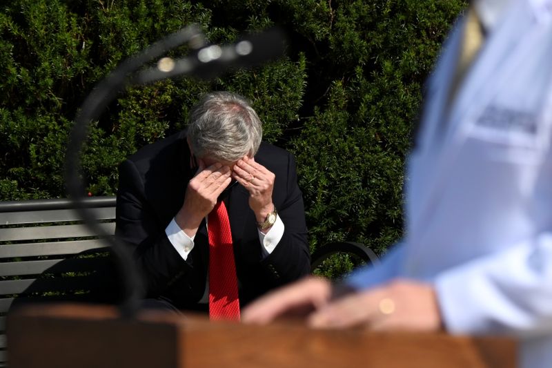 White House Chief of Staff Mark Meadows rubs his head