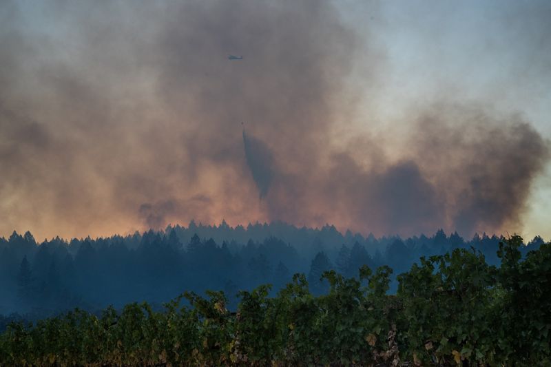 Helicopter drops water over the Glass Fire in Calistoga, California