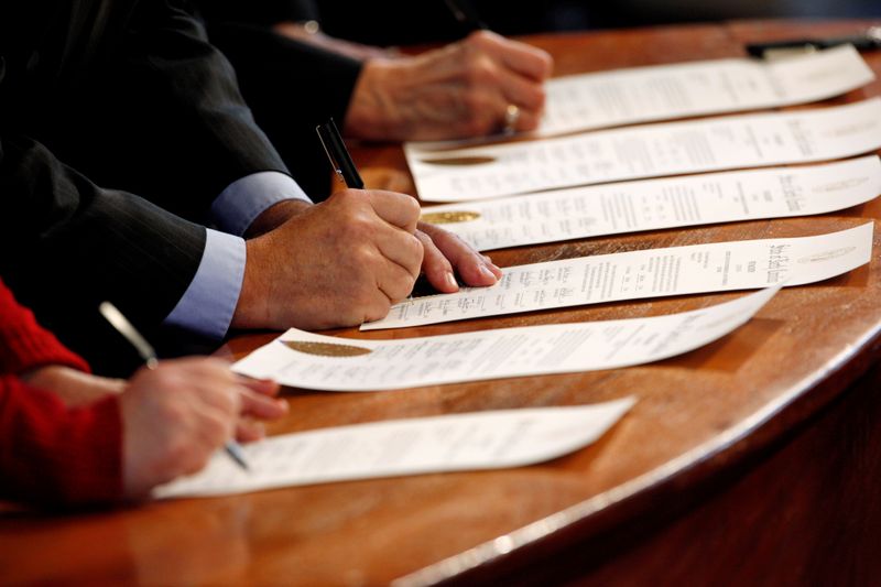 FILE PHOTO: North Carolina Electoral College representatives sign the Certificates