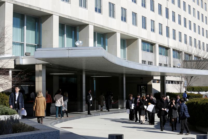 People enter and leave State Department Building in Washington