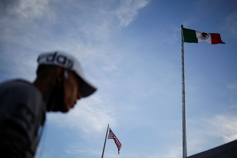 The flags of the U.S. and Mexico flutter at the