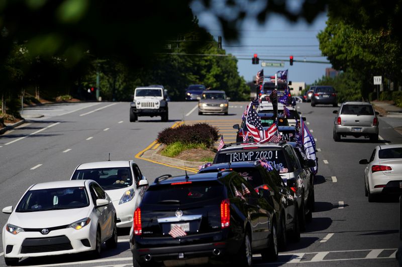 FILE PHOTO: Vehicles fly pro-Trump flags while participating in a