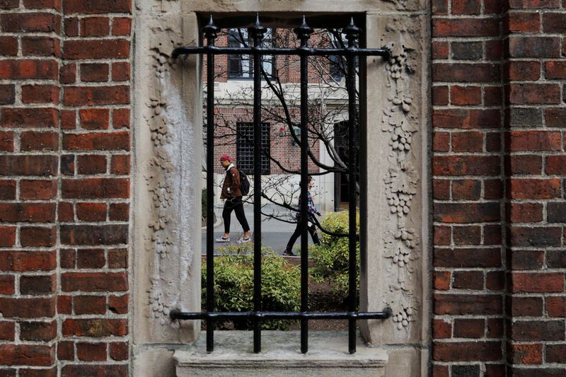 Students and pedestrians walk through the Yard at Harvard University