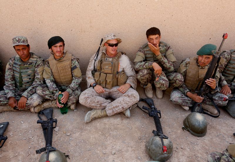 FILE PHOTO: A U.S. Marine talks with Afghan National Army