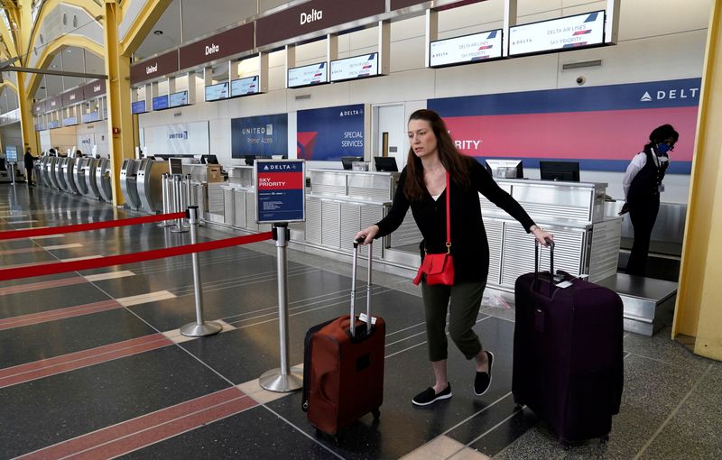 FILE PHOTO: Lone passenger leaves a Delta Airlines counter after