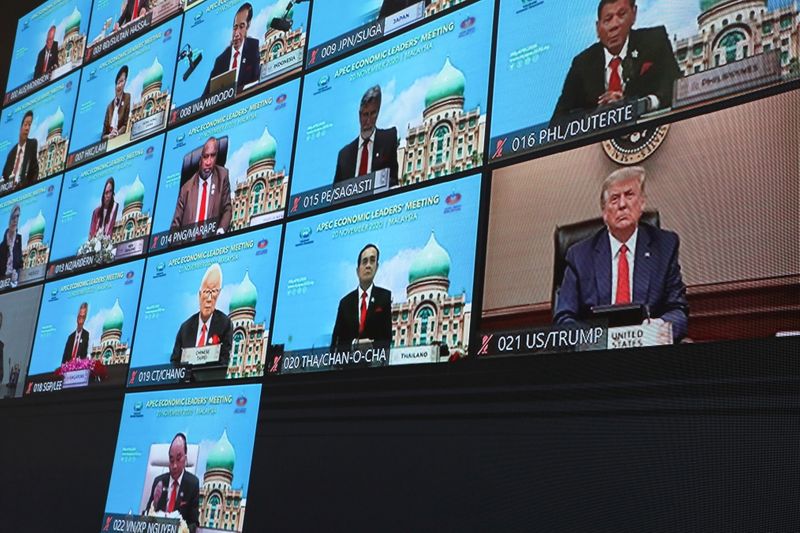 U.S. President Donald Trump is seen on a screen attending