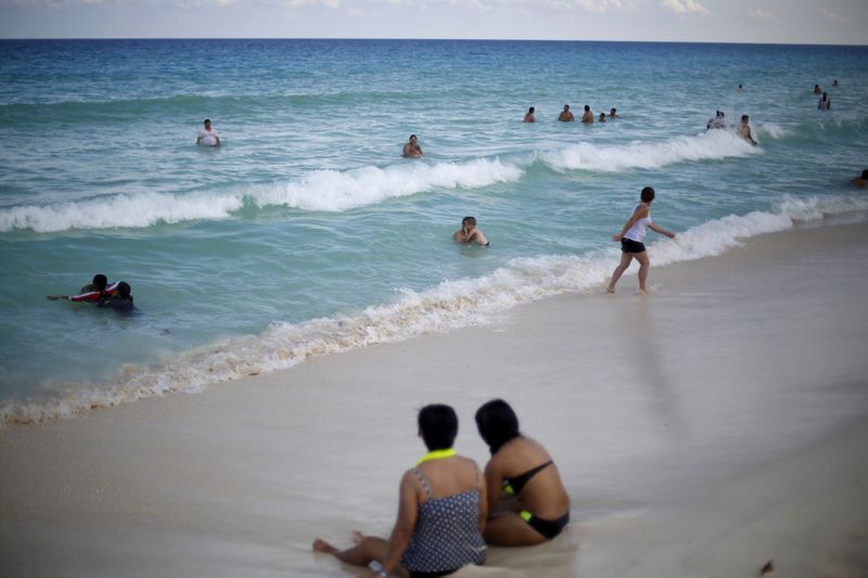 FILE PHOTO: Tourists bathe on a beach in Cancun