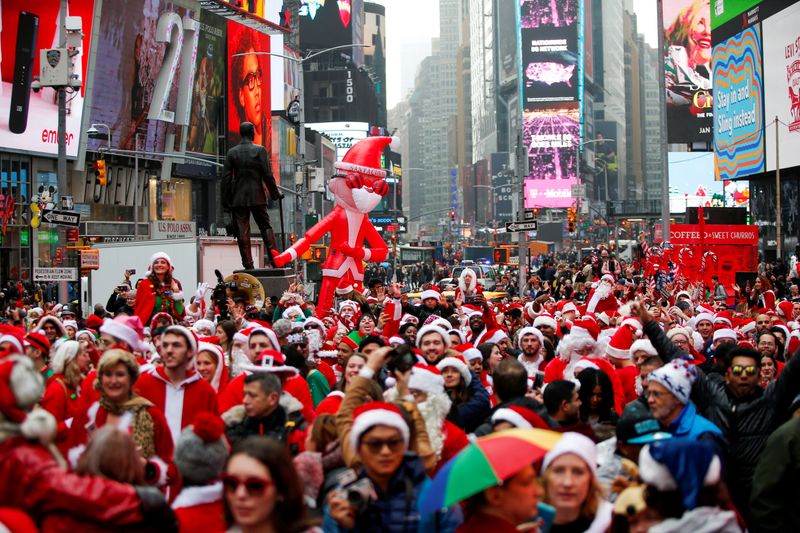 FILE PHOTO: Revelers dressed as Santa Claus take part in