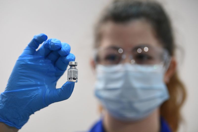 FILE PHOTO: A member of medical staff holds a phial