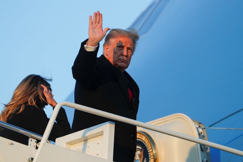 U.S. President Donald Trump boards Air Force One beside first