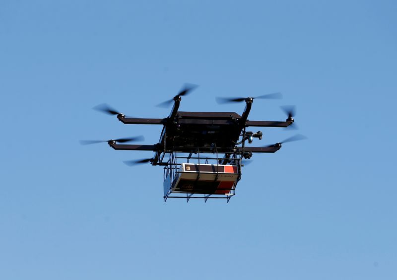 FILE PHOTO: A drone demonstrates delivery capabilities from the top