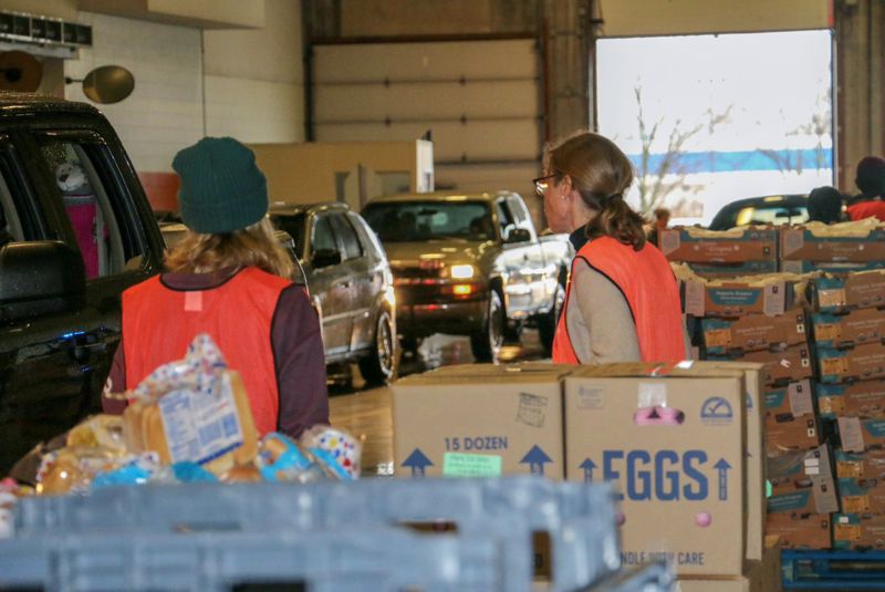 Gleaners Food Bank volunteers assist with curbside food distribution in