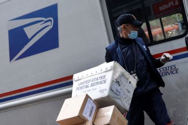 United States Postal Service (USPS) worker unloads packages in Manhattan