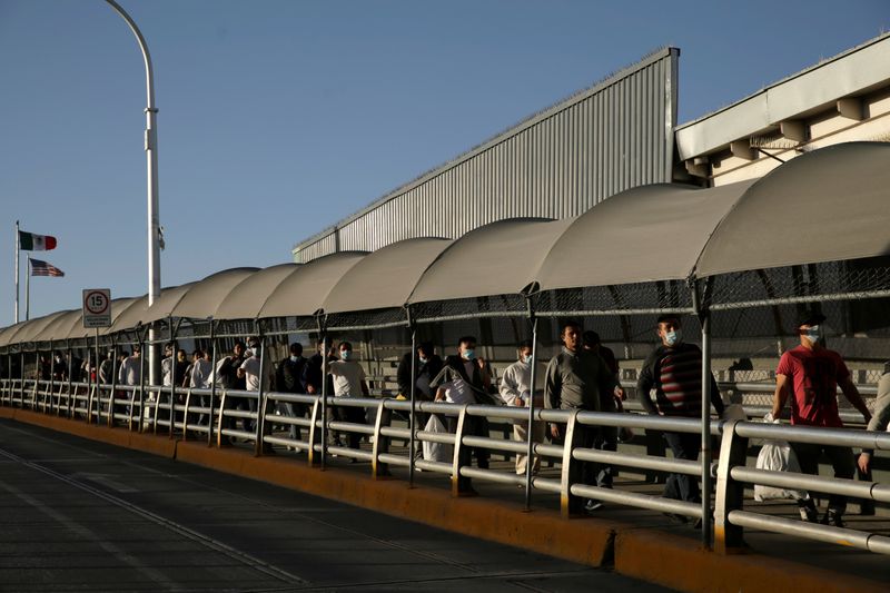 Mexican immigrants walk across the Paso del Norte border bridge
