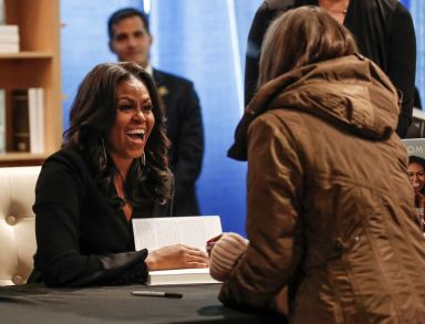FILE PHOTO: Former first lady Michelle Obama signs copies of