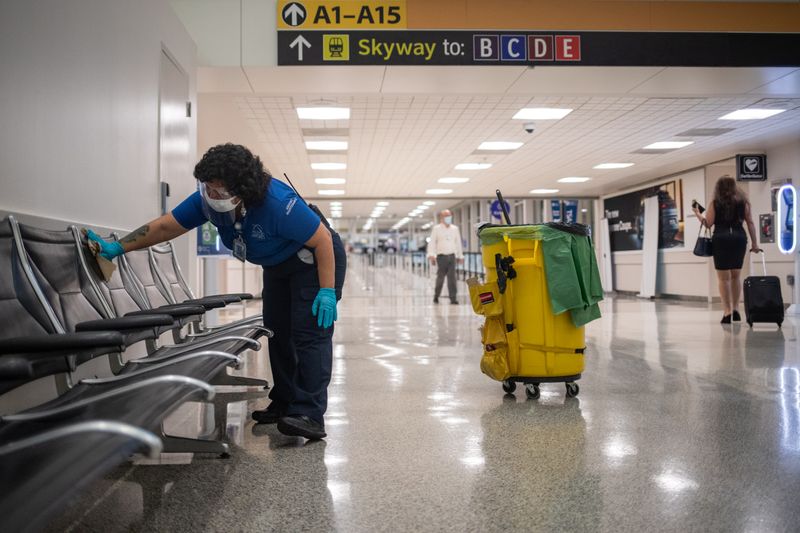 Airport custodian clean seats at IAH George Bush Intercontinental Airport