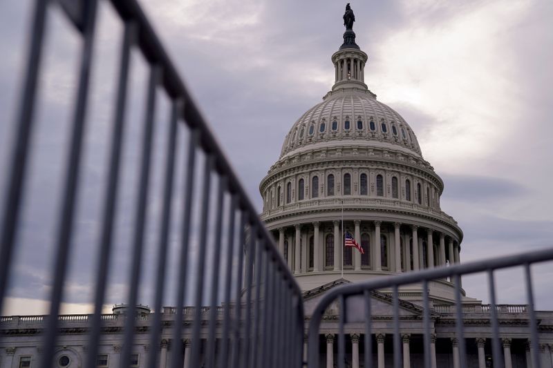 The U.S. Capitol is seen behind a fence in Washington